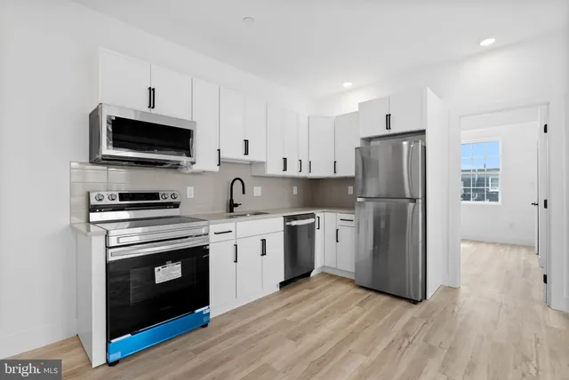 a kitchen with stainless steel appliances a refrigerator stove and microwave