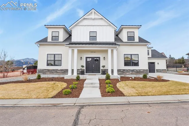 a view of a house with swimming pool and sitting area