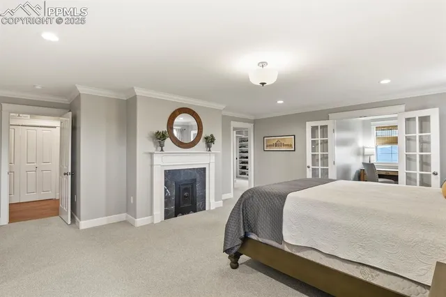 a spacious bedroom with a bed and a fireplace