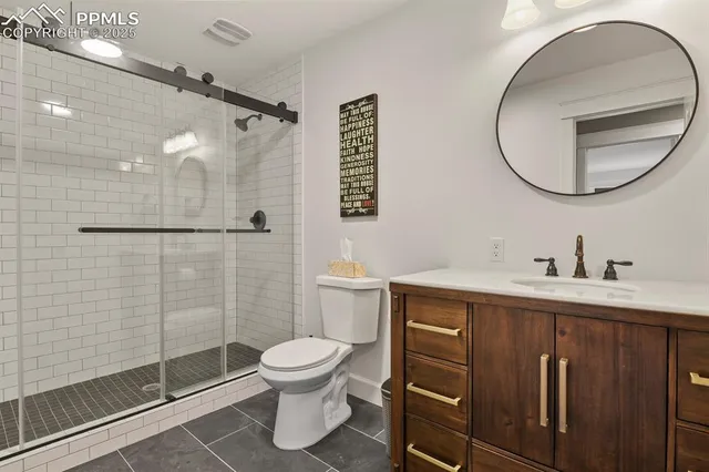 a bathroom with a sink a toilet and a mirror