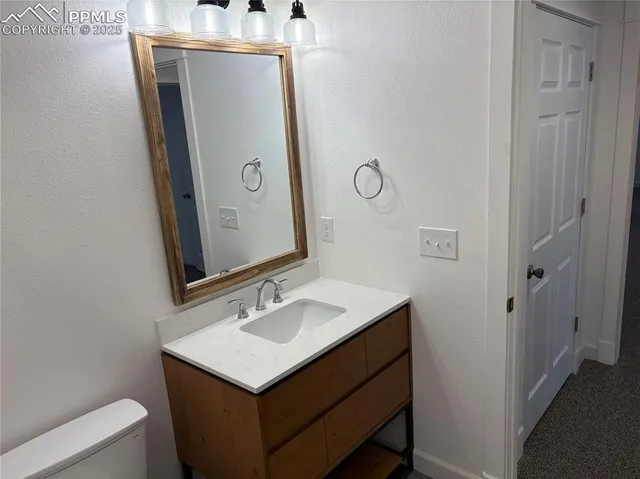 a bathroom with a sink vanity and mirror