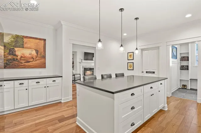 a kitchen with white cabinets and sink