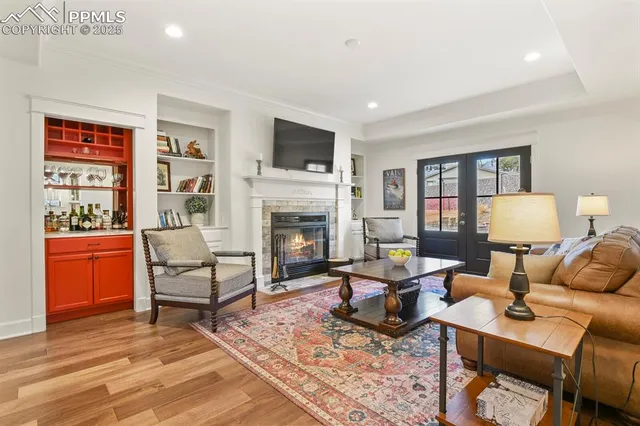 a living room with furniture a flat screen tv and a fireplace