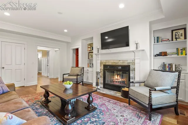 a living room with furniture a flat screen tv and a fireplace