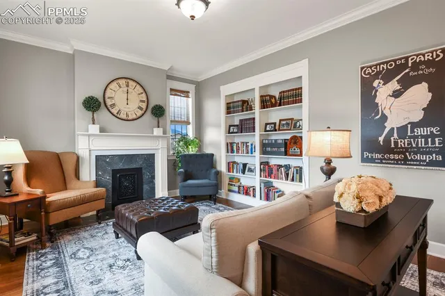 a living room with fireplace furniture and decor