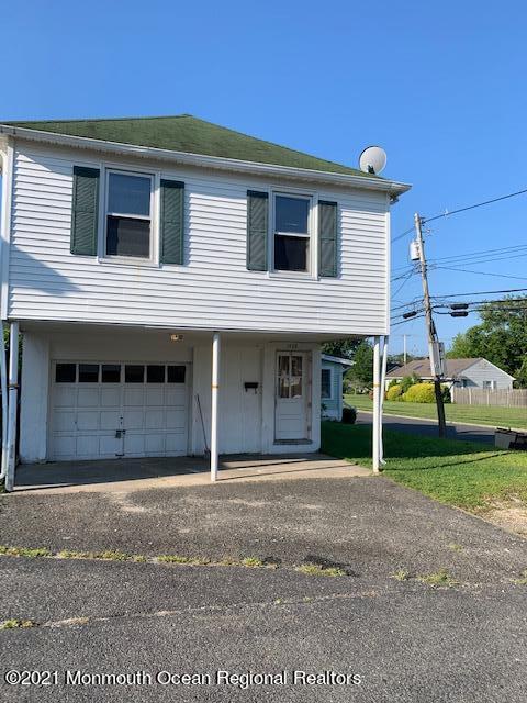 1428 6th Avenue Neptune, NJ 07753 - Photo 1 of 6 a front view of a house with a garden