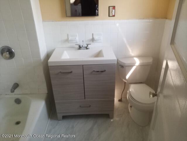 1428 6th Avenue Neptune, NJ 07753 - Photo 2 of 6 a bathroom with a sink toilet and shower