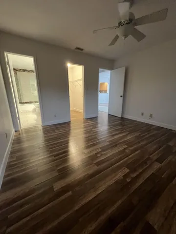 a view of an empty room and wooden floor