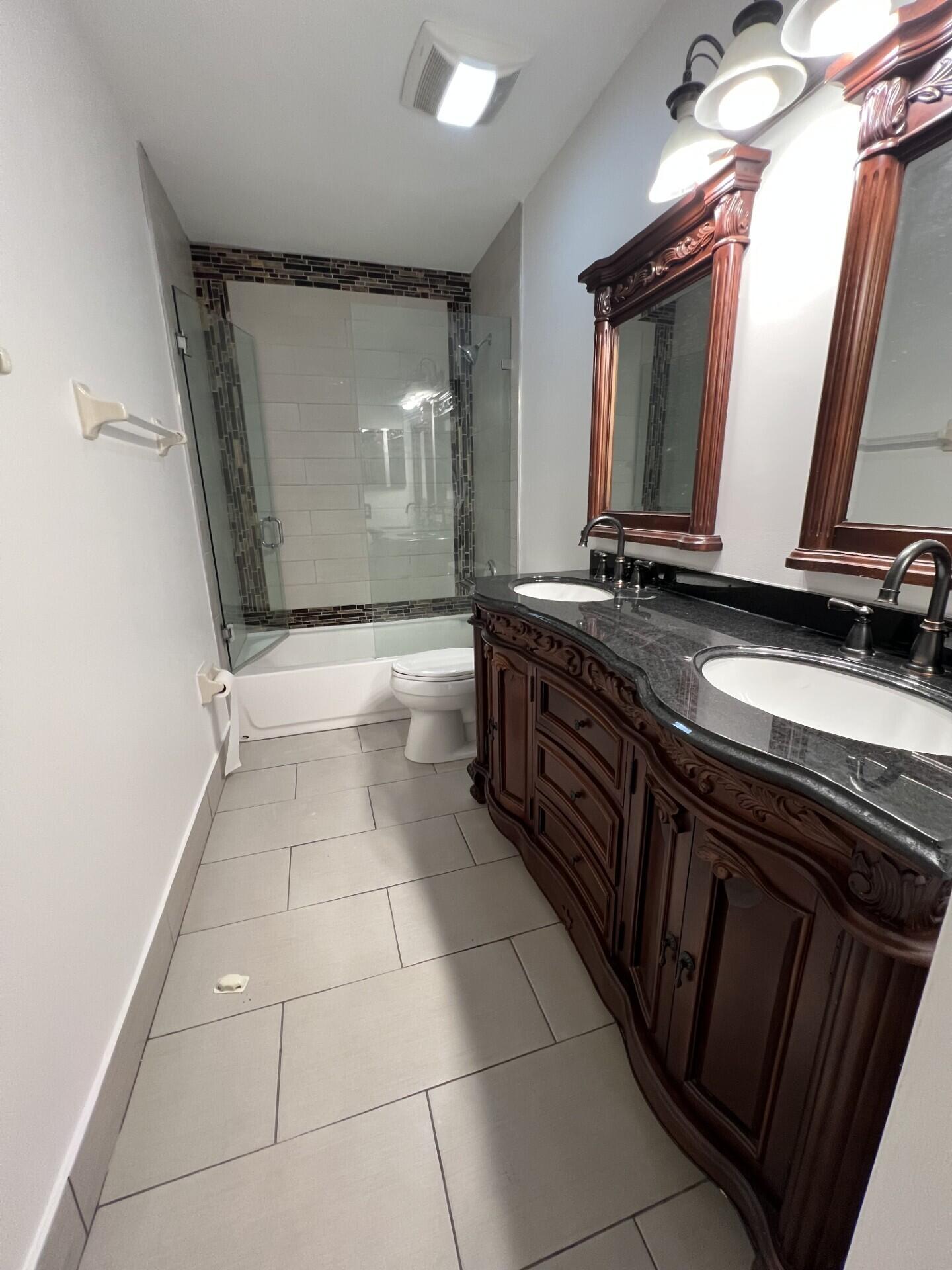 9314 Ketay Circle Boca Raton, FL 33428 - Photo 13 of 22 a bathroom with a double vanity sink and mirror