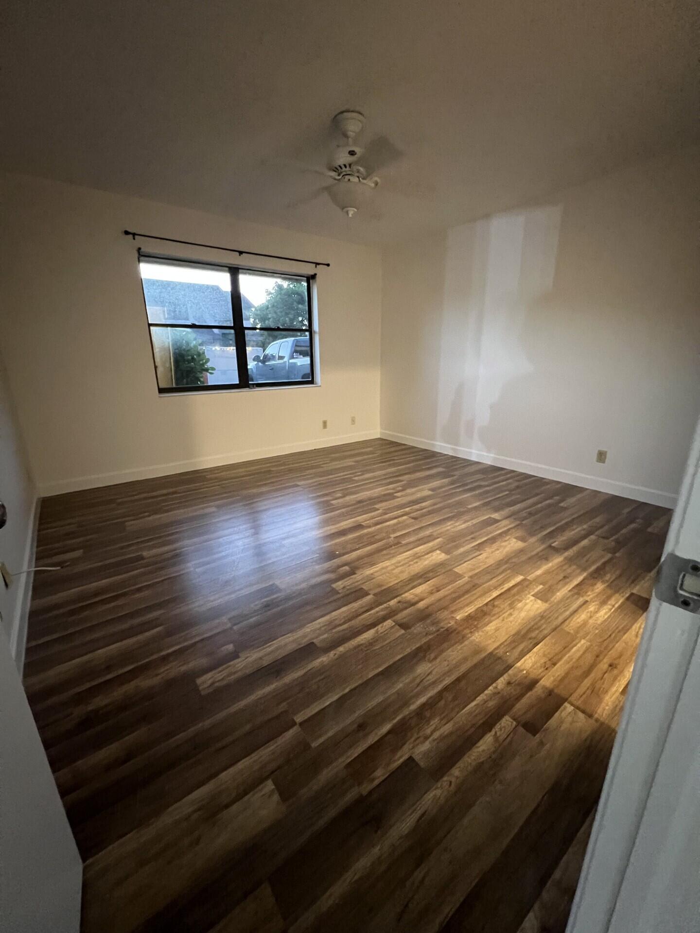 9314 Ketay Circle Boca Raton, FL 33428 - Photo 14 of 22 a view of an empty room and wooden floor