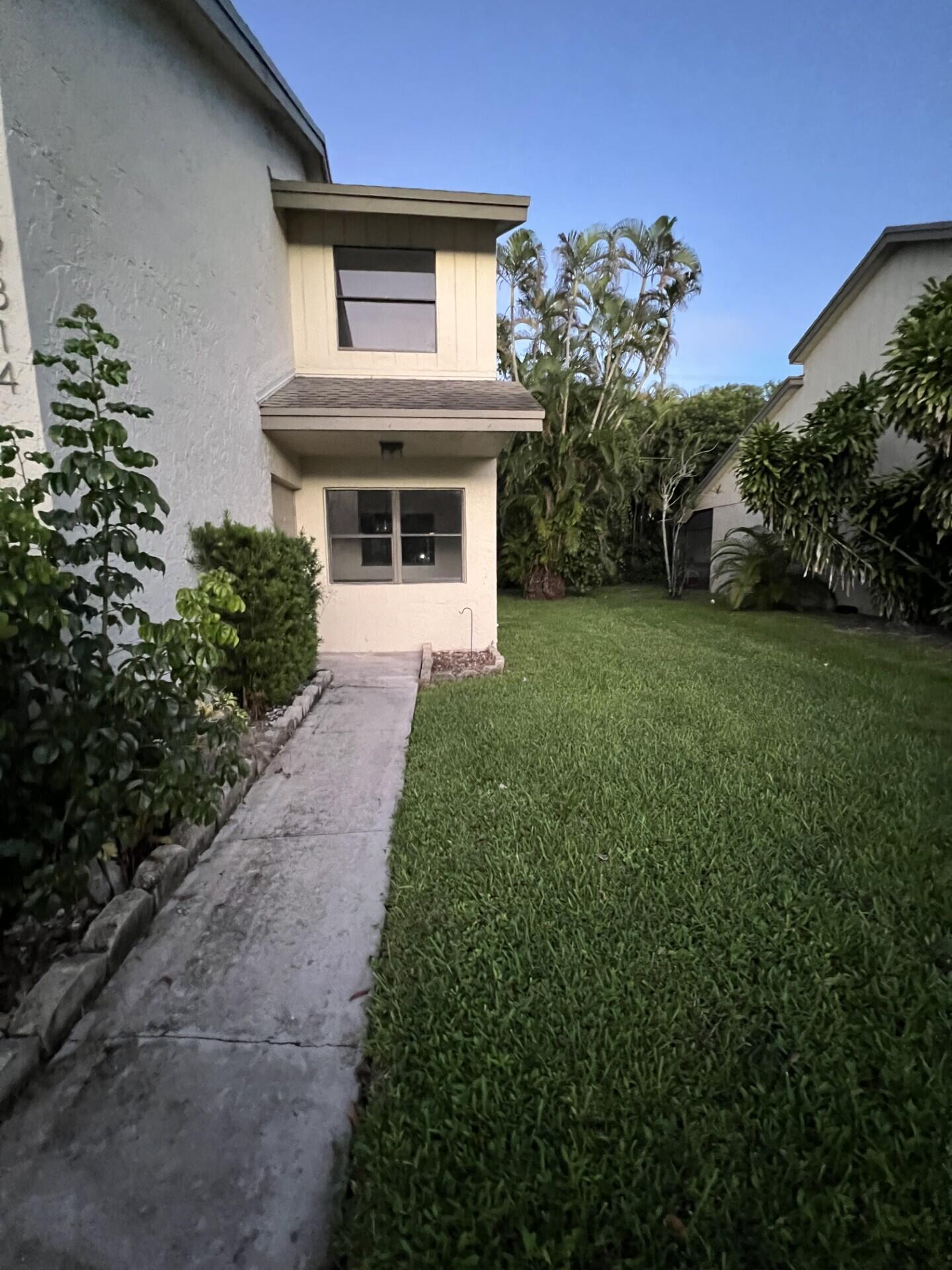 9314 Ketay Circle Boca Raton, FL 33428 - Photo 5 of 22 a front view of a house with garden