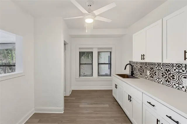 a view of a kitchen with a sink stainless steel appliances and cabinets