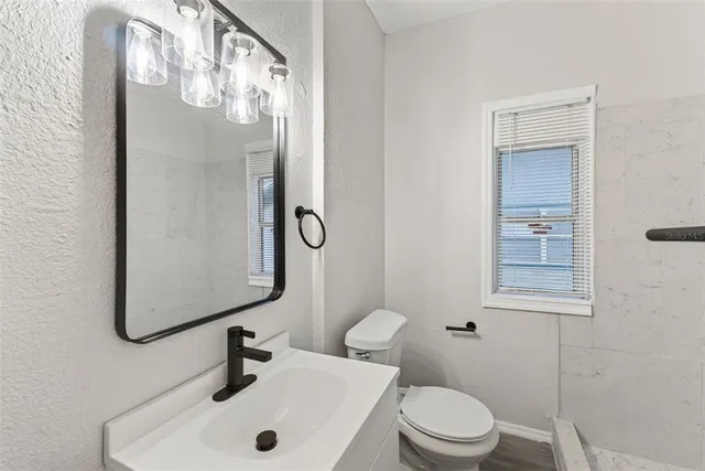 a view of a workspace with furniture and a book shelf