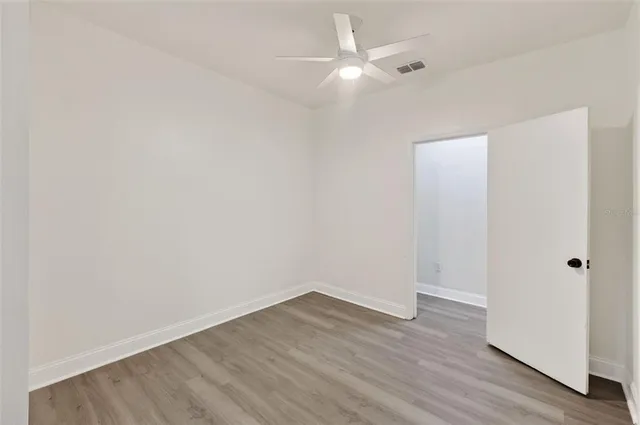 a front view of house with yard and trees in the background