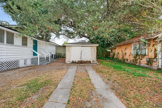 a front view of a house with a yard and potted plants