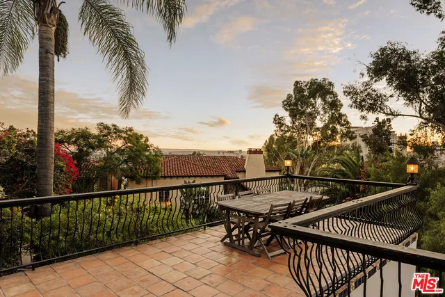 a view of a balcony with two chairs and a table