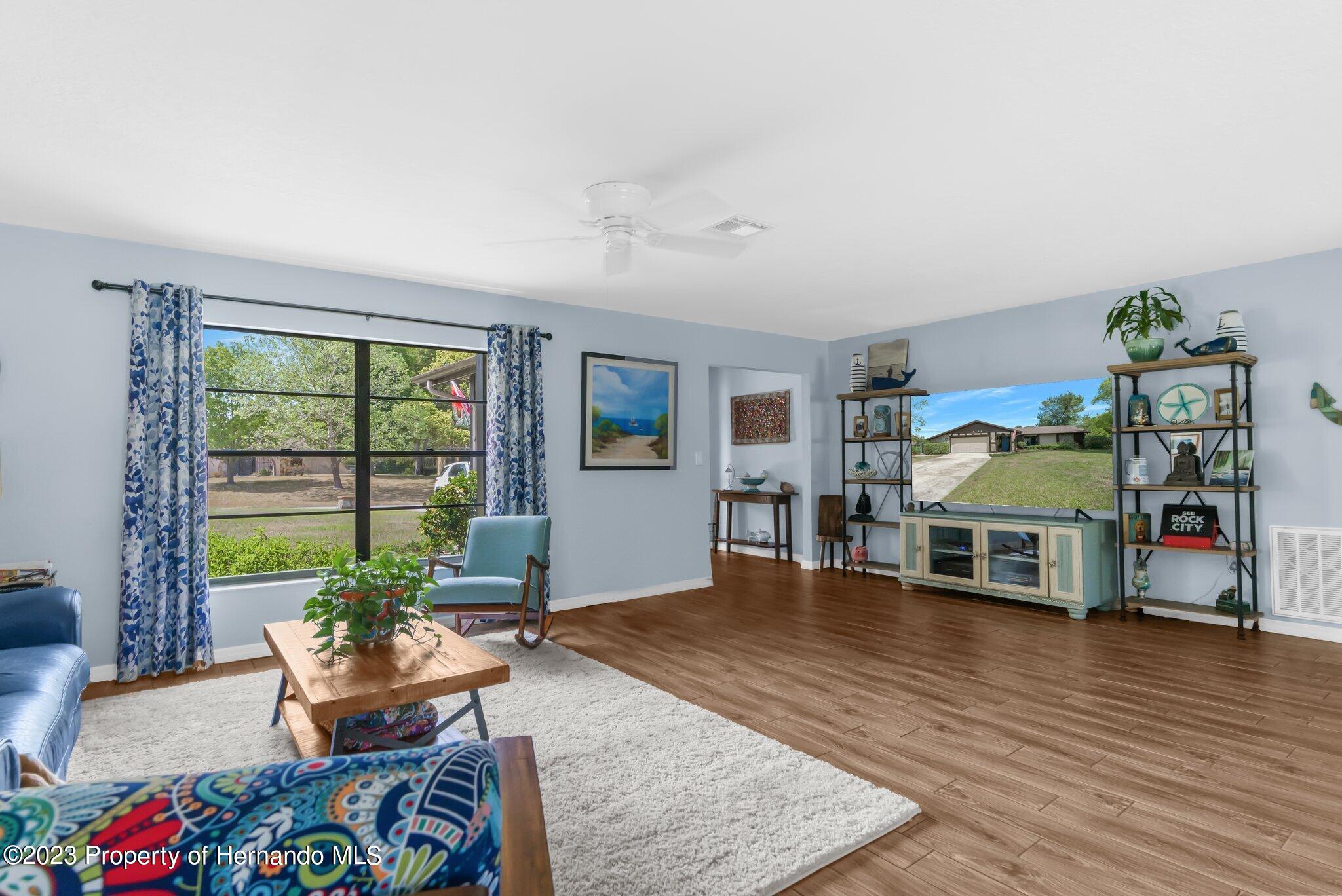 5396 Fern Weeki Wachee, FL 34607 - Photo 11 of 43 a living room with furniture and a wooden floor