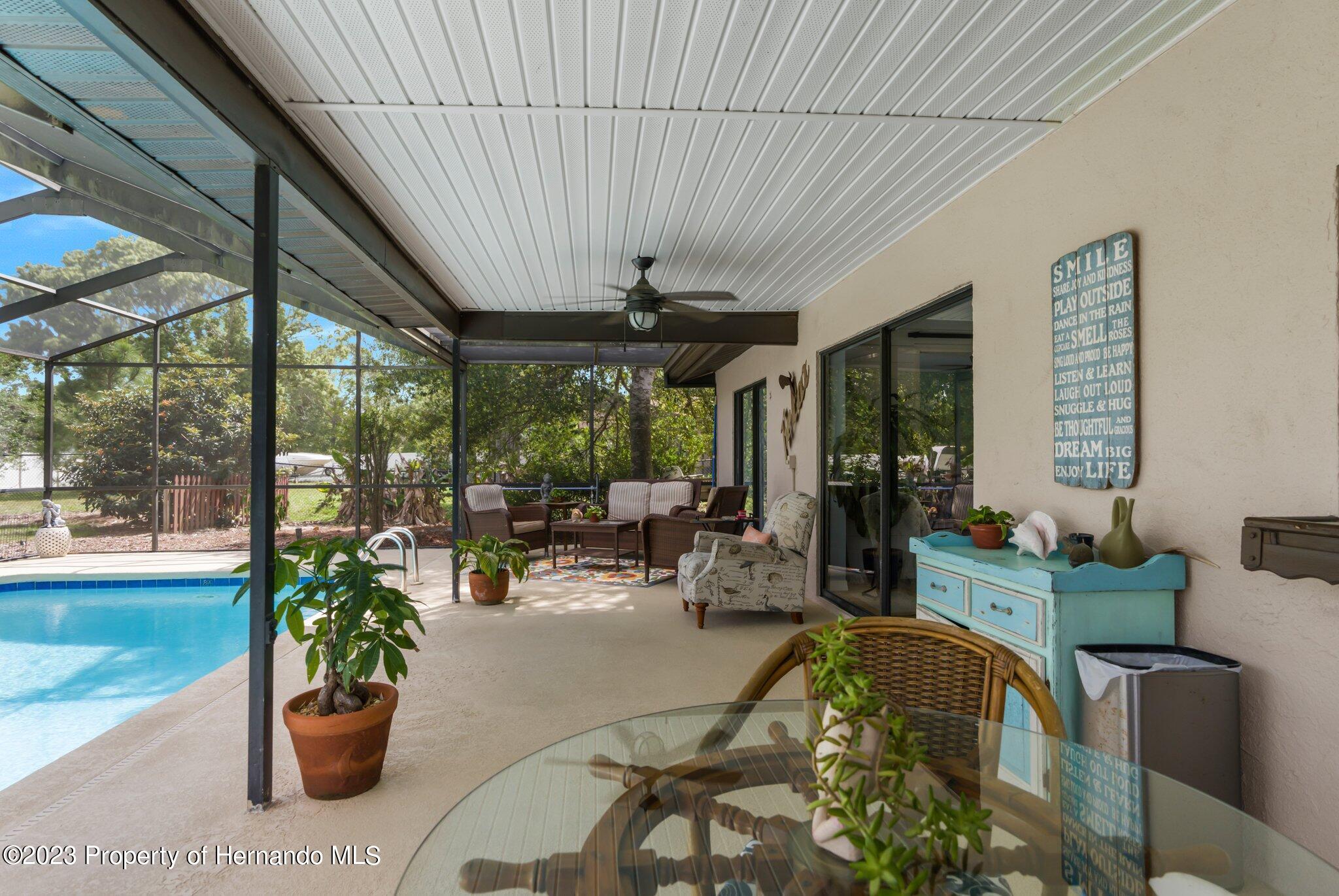 5396 Fern Weeki Wachee, FL 34607 - Photo 31 of 43 a view of a patio with a dining table and chairs
