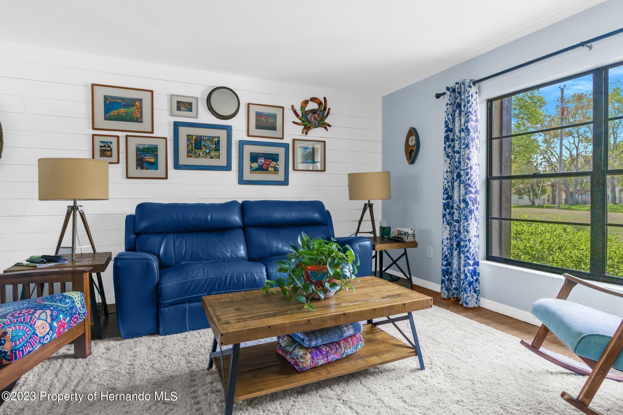 5396 Fern Weeki Wachee, FL 34607 - Photo 7 of 43 a living room with furniture a table and a large window