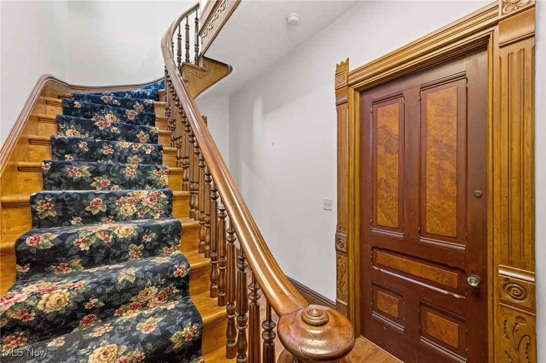 Stairway featuring wood finished floors