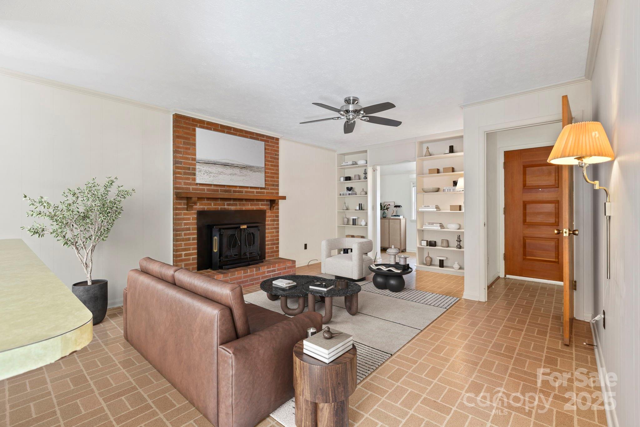 109 Rusty Lane Hendersonville, NC 28791 - Photo 11 of 34 a living room with furniture a chandelier and a fireplace