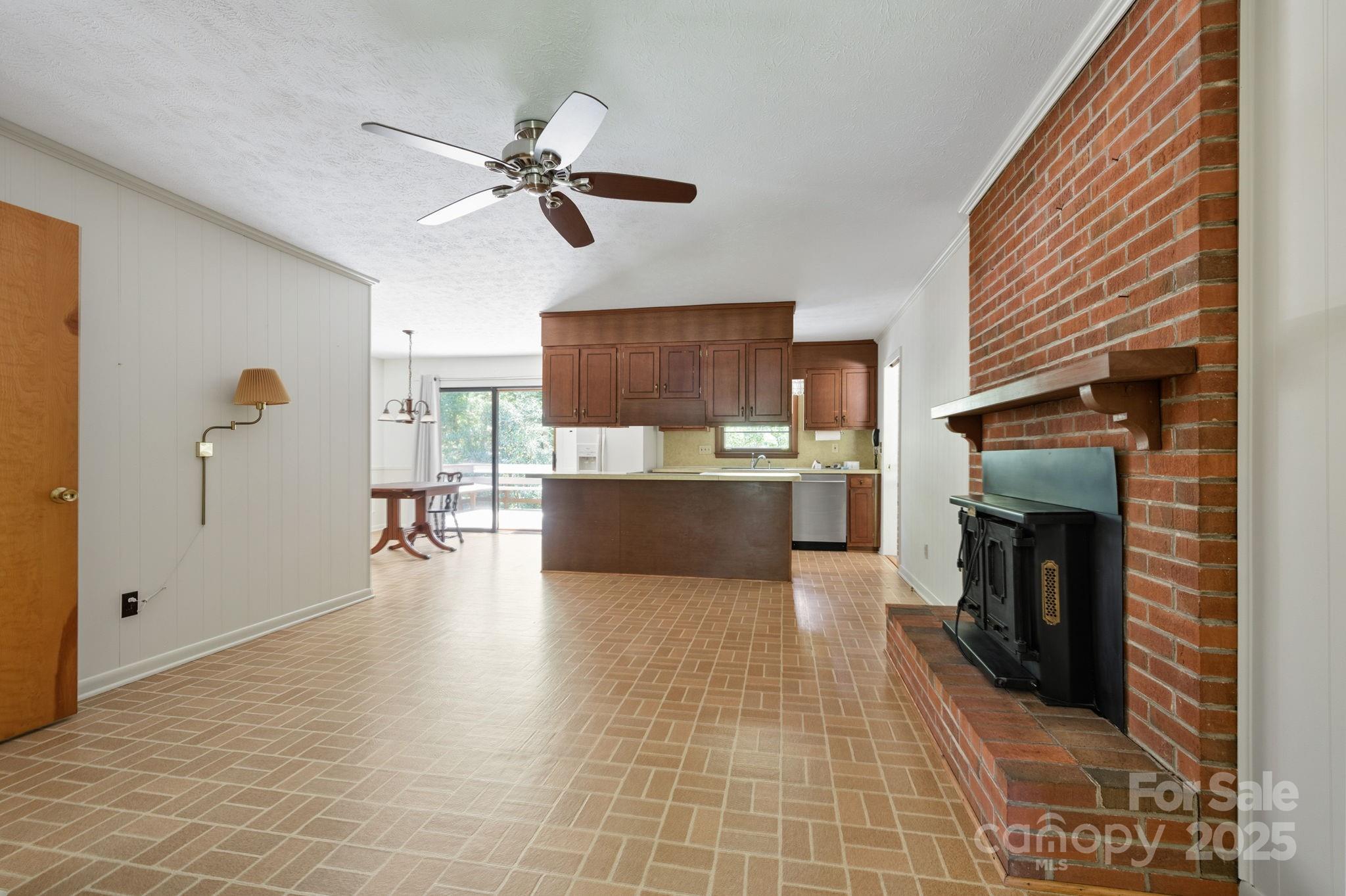 109 Rusty Lane Hendersonville, NC 28791 - Photo 12 of 34 a view of a kitchen with a sink cabinets and a fireplace