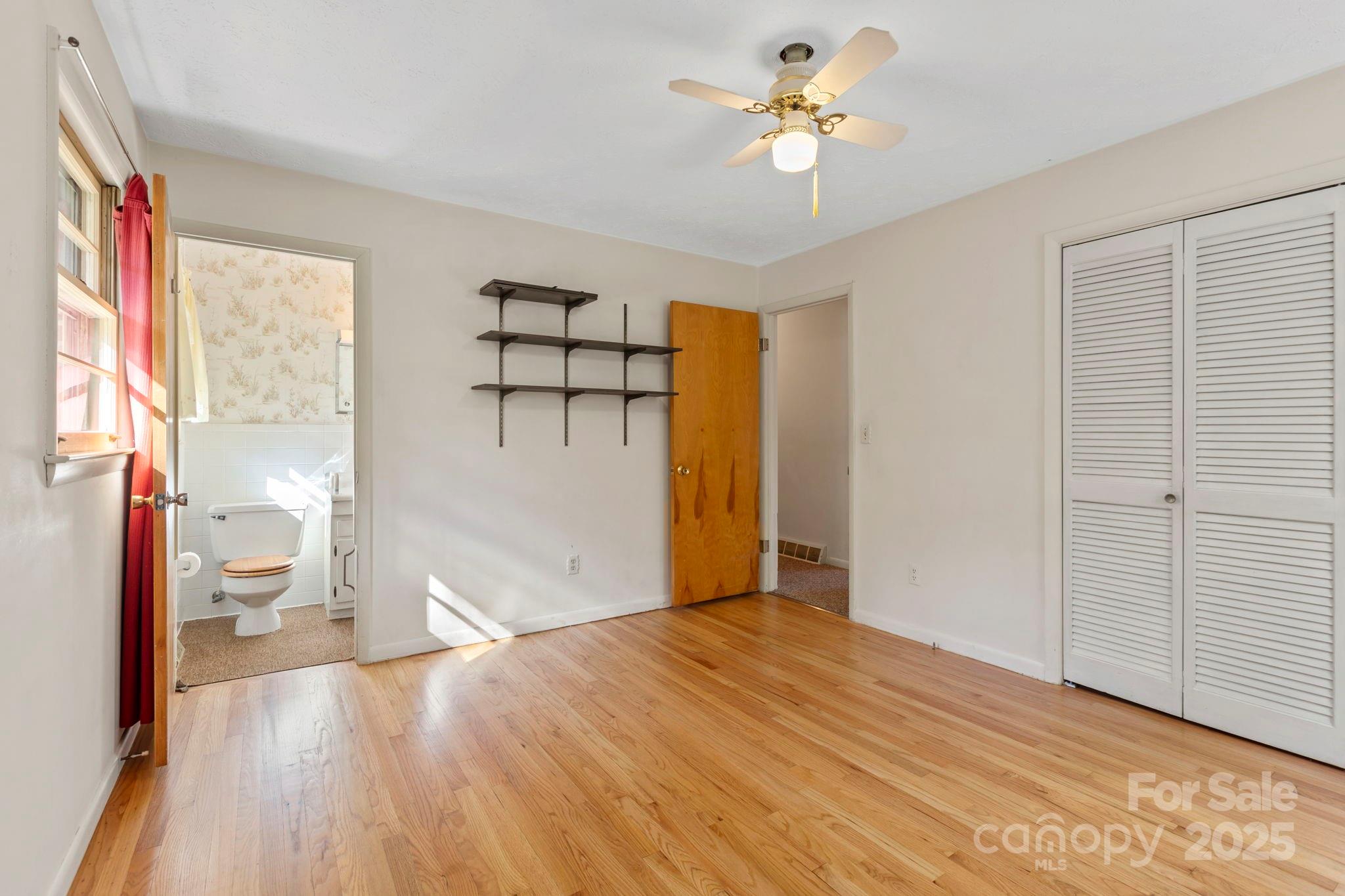 109 Rusty Lane Hendersonville, NC 28791 - Photo 18 of 34 a view of empty room with wooden floor and fan