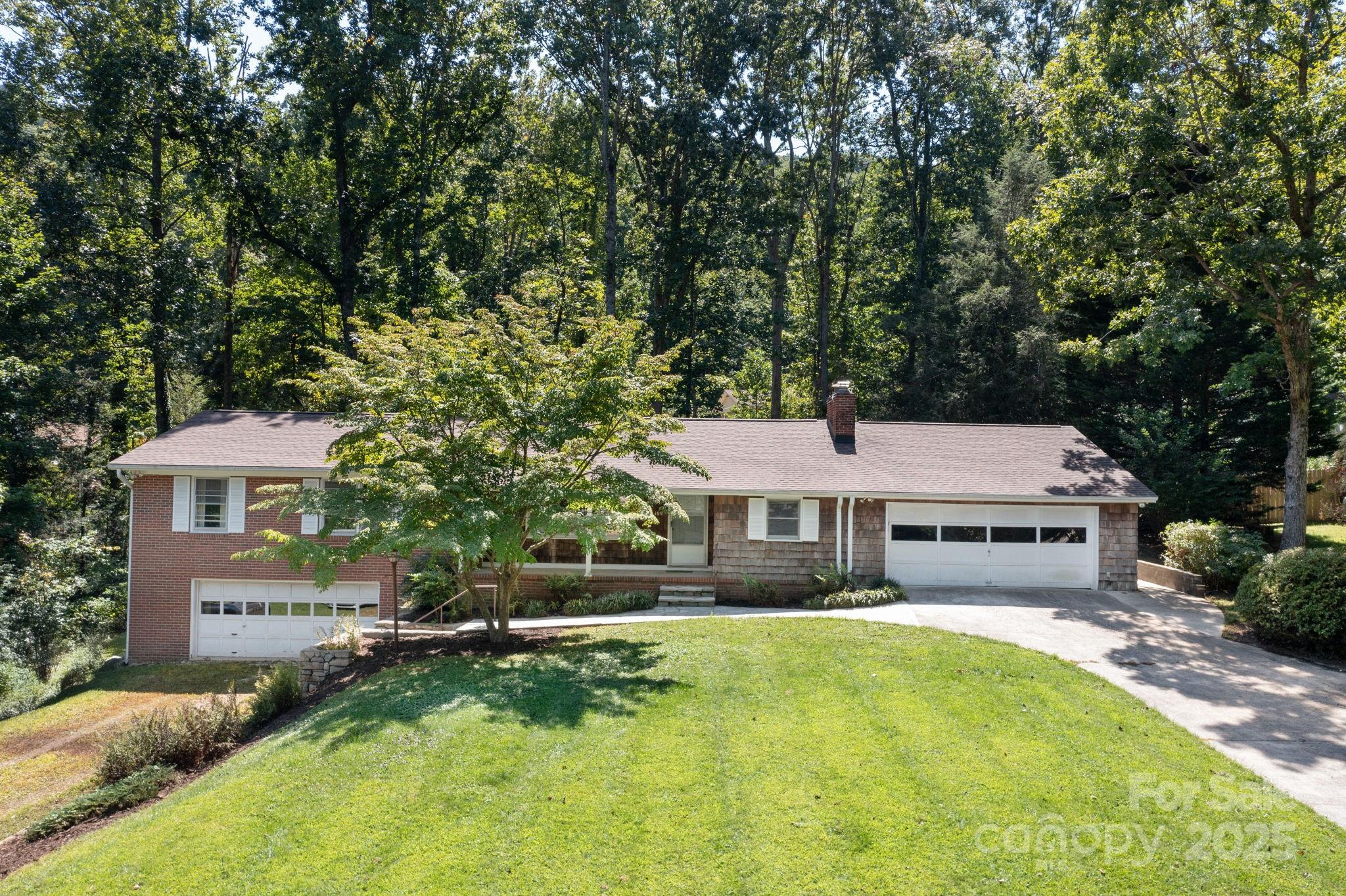 109 Rusty Lane Hendersonville, NC 28791 - Photo 2 of 34 a front view of a house with a yard