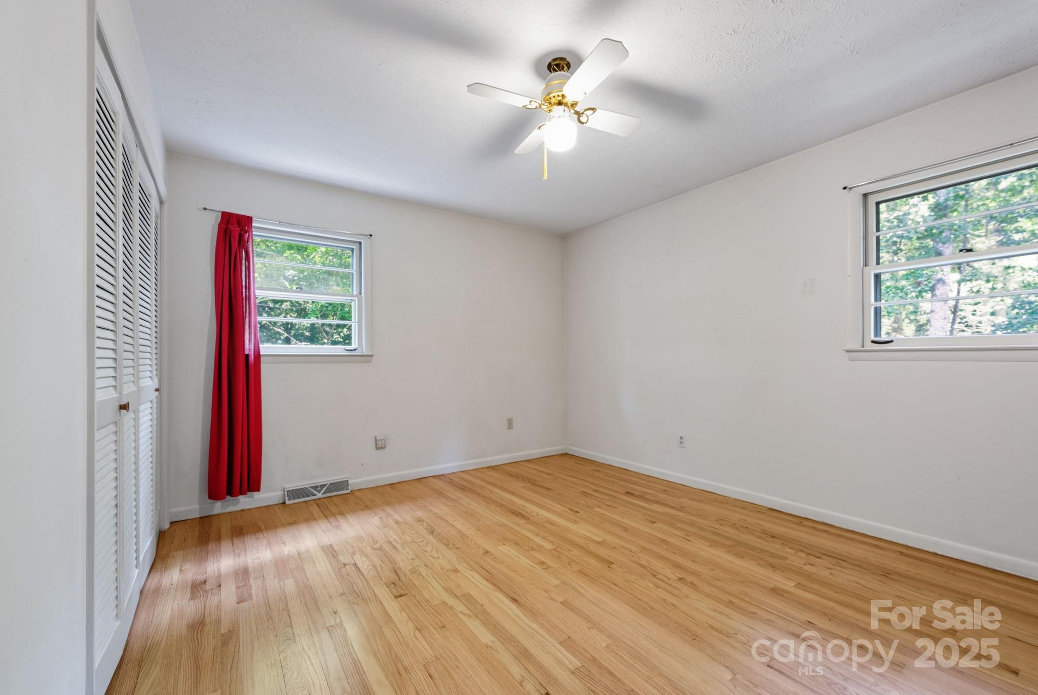 109 Rusty Lane Hendersonville, NC 28791 - Photo 21 of 34 a view of empty room with wooden floor and fan