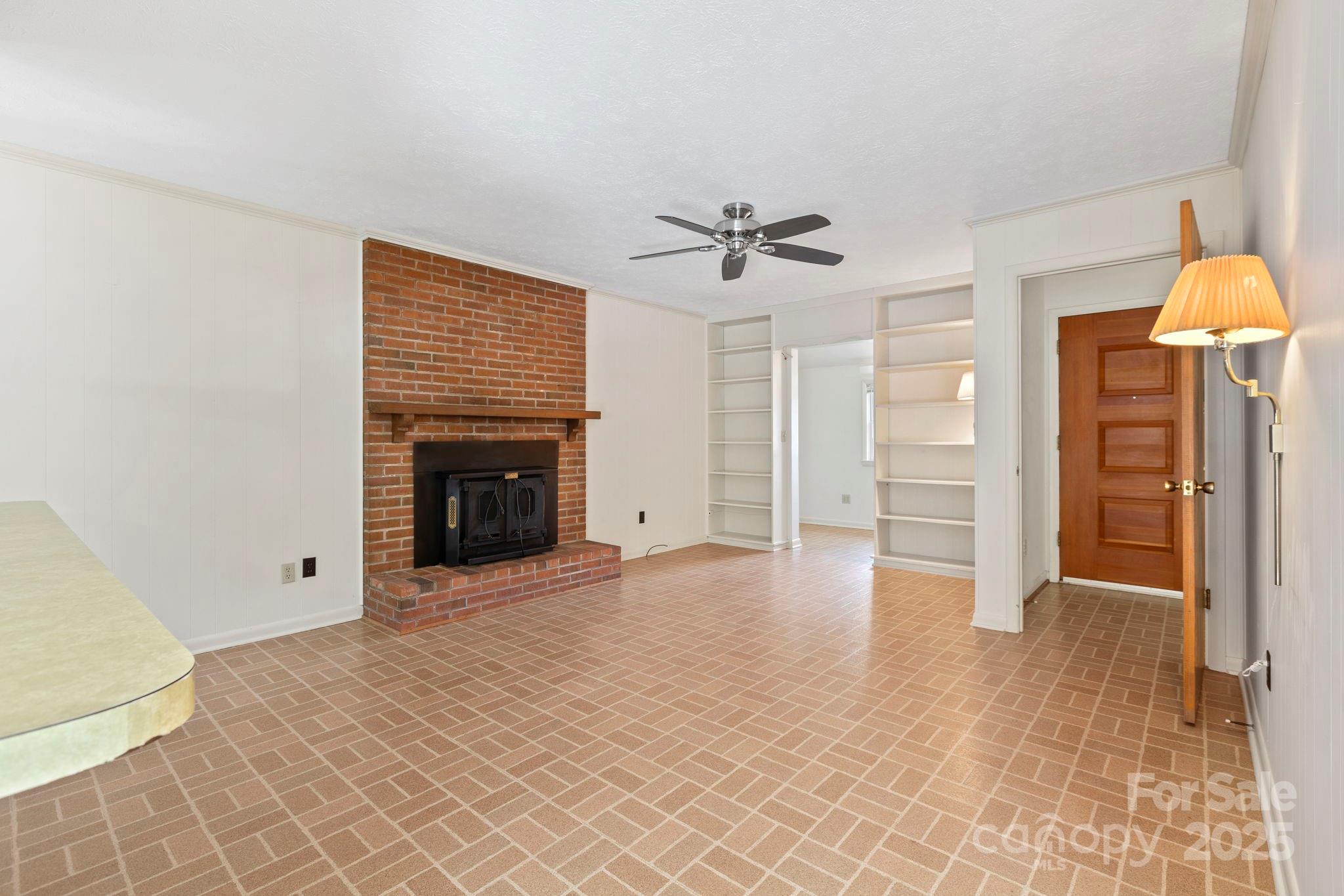 109 Rusty Lane Hendersonville, NC 28791 - Photo 10 of 34 a view of an empty room with a fireplace and a window