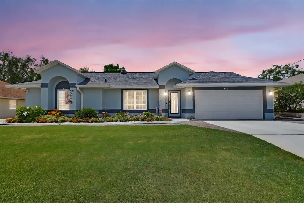 1366 Valhalla Street Deltona, FL 32725 - Photo 1 of 1 a front view of a house with a garden and yard