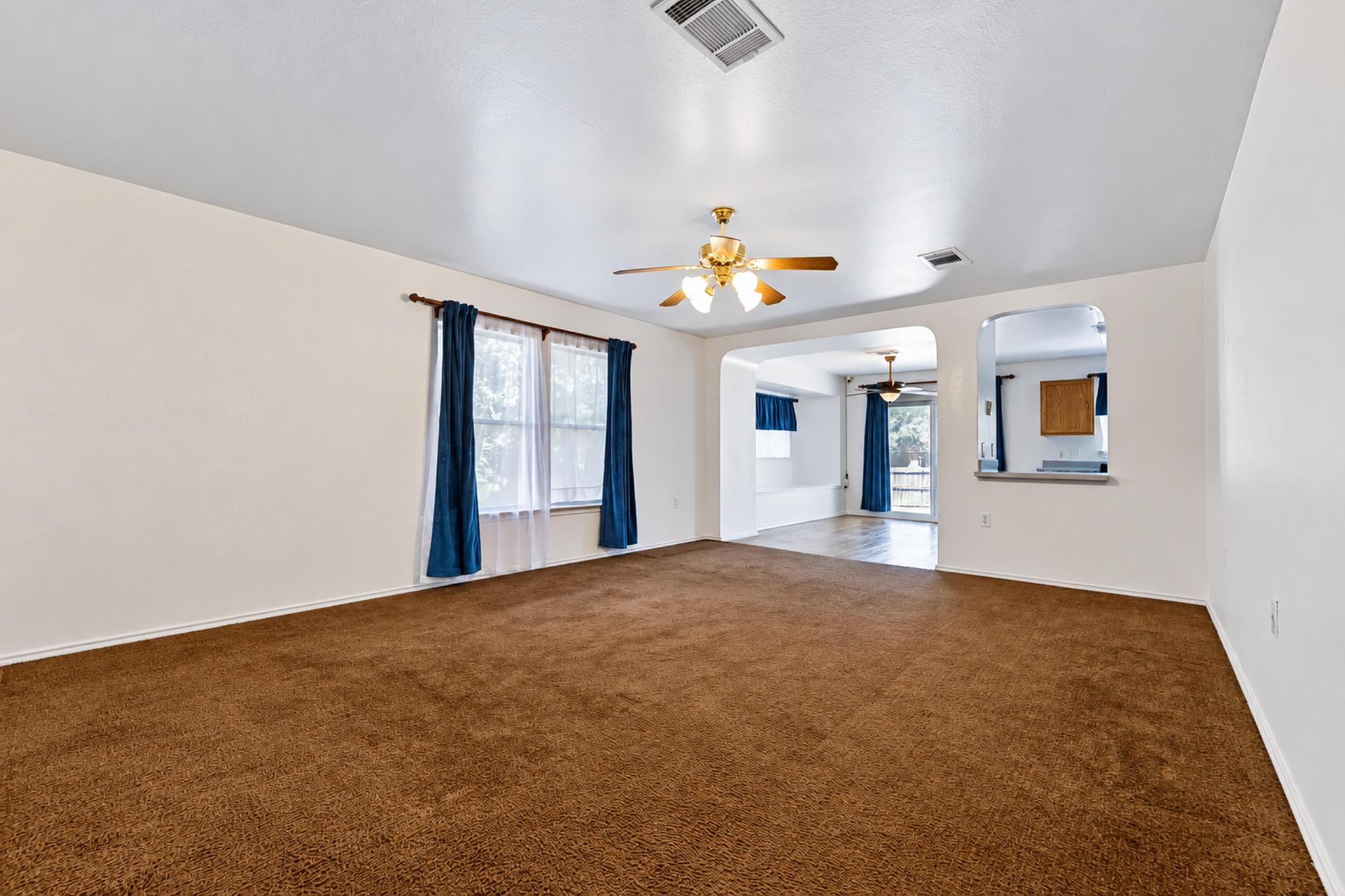 7317 Marble Ridge Drive Austin, TX 78747 - Photo 10 of 30 Deep carpeting and open arched doorways define this versatile living area.