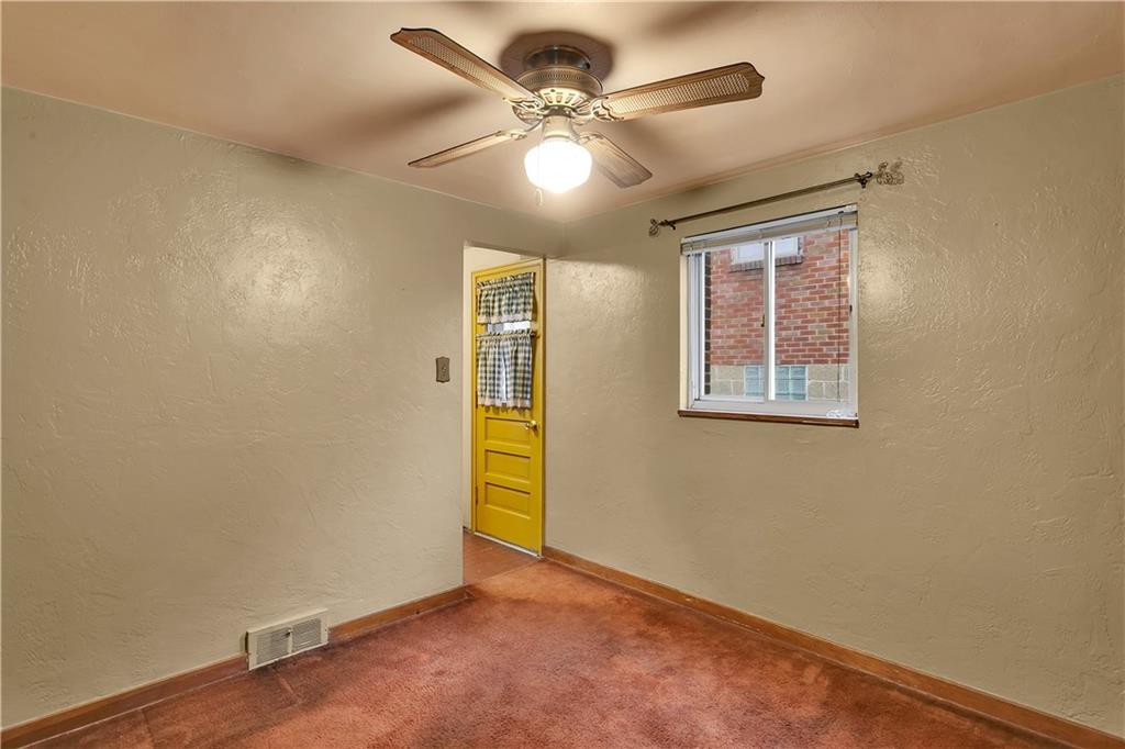 3512 Willett Road Pittsburgh, PA 15227 - Photo 11 of 23 an empty room with a chandelier fan and windows