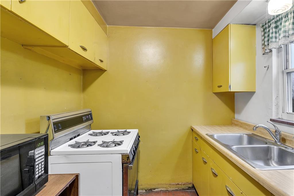 3512 Willett Road Pittsburgh, PA 15227 - Photo 13 of 23 a utility room with a sink a stove and a refrigerator