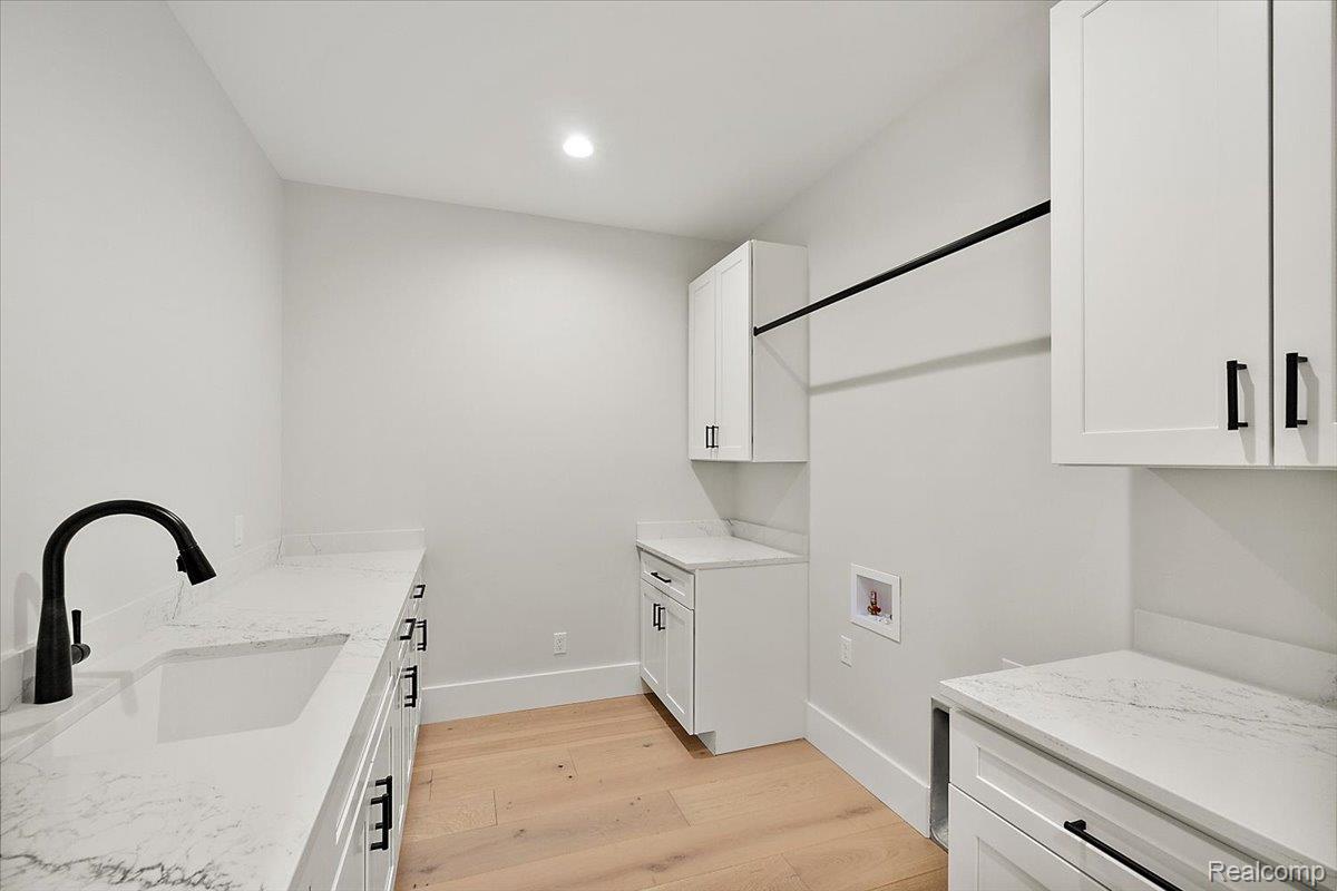 13459 Haddon Street Fenton, MI 48430 - Photo 44 of 84 Laundry area with light wood finished floors, cabinet space, washer hookup, and recessed lighting