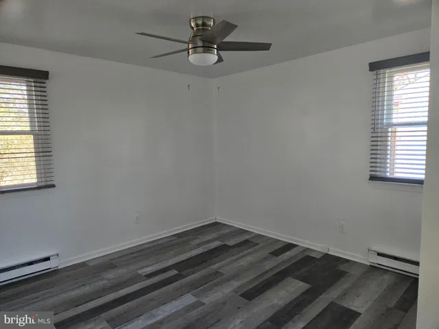 a room with a window and a ceiling fan