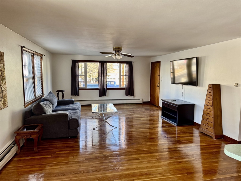 156 Nichols Avenue, Unit 1 Watertown, MA 02472 - Photo 11 of 26 a living room with fireplace furniture and a flat screen tv