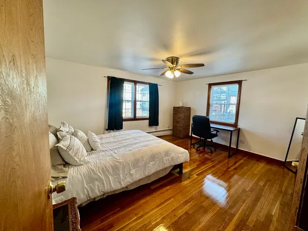 a bedroom with a bed a table and chair