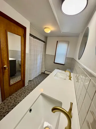 a bedroom with a bed and a mirror