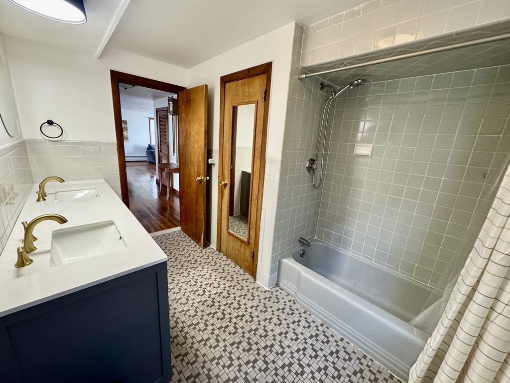 156 Nichols Avenue, Unit 1 Watertown, MA 02472 - Photo 19 of 26 a bathroom with a sink a toilet and shower