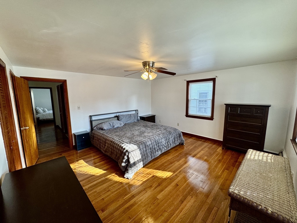 156 Nichols Avenue, Unit 1 Watertown, MA 02472 - Photo 21 of 26 a bedroom with a bed and a dresser with rug