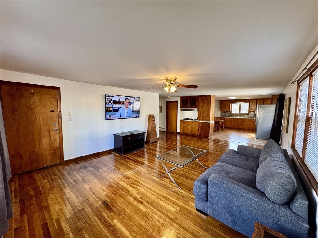 156 Nichols Avenue, Unit 1 Watertown, MA 02472 - Photo 24 of 26 a living room with furniture and a wooden floor
