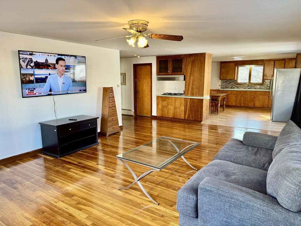 156 Nichols Avenue, Unit 1 Watertown, MA 02472 - Photo 25 of 26 a living room with furniture a flat screen tv and a table