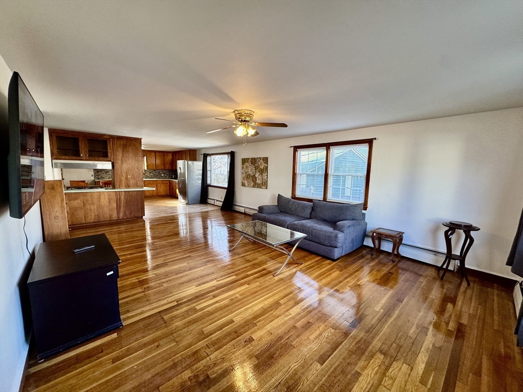 156 Nichols Avenue, Unit 1 Watertown, MA 02472 - Photo 26 of 26 a living room with furniture and a wooden floor