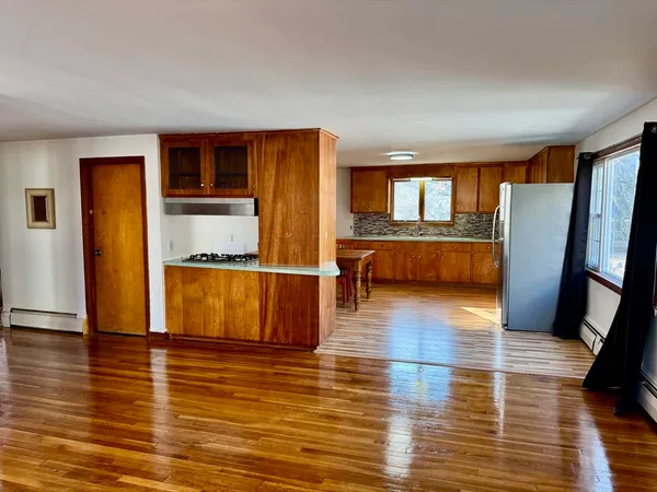 a view of kitchen with furniture and wooden floor