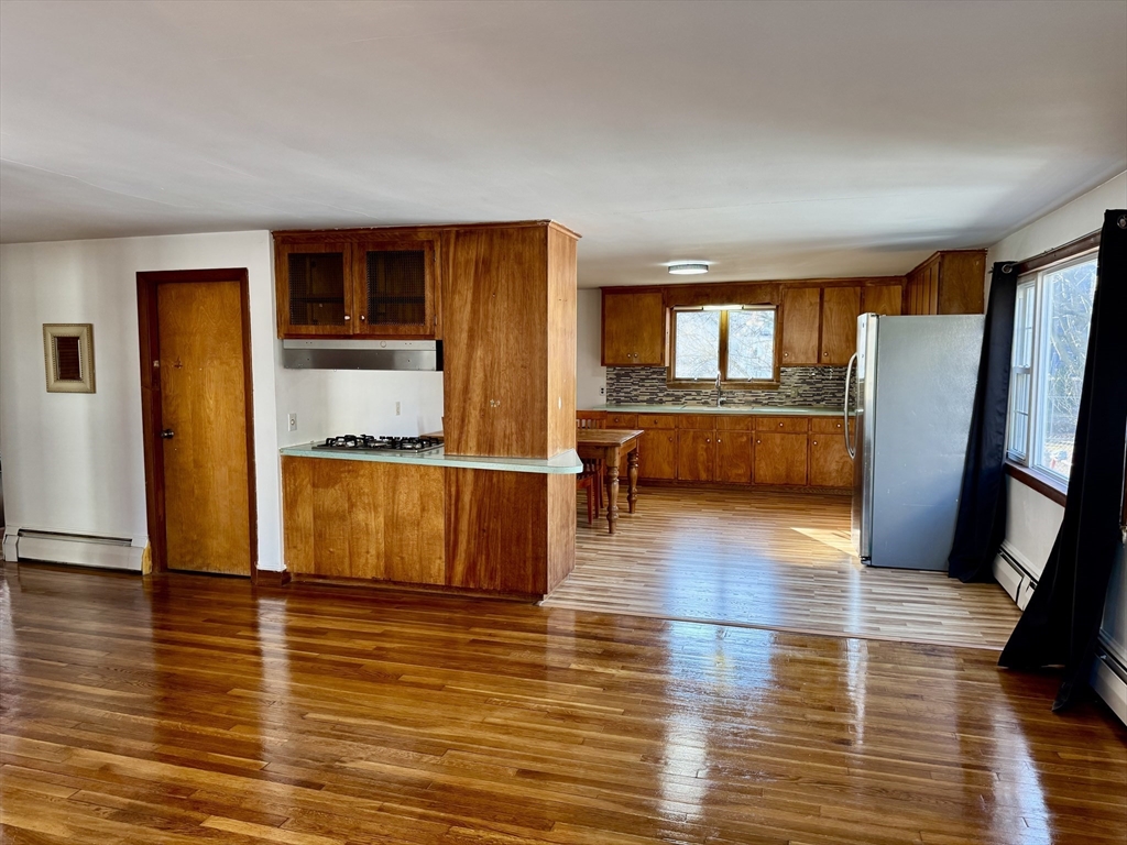156 Nichols Avenue, Unit 1 Watertown, MA 02472 - Photo 3 of 26 a view of kitchen with furniture and wooden floor