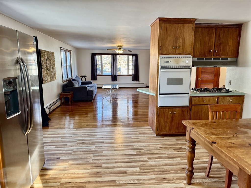 156 Nichols Avenue, Unit 1 Watertown, MA 02472 - Photo 9 of 26 a kitchen view with wooden floor and furniture