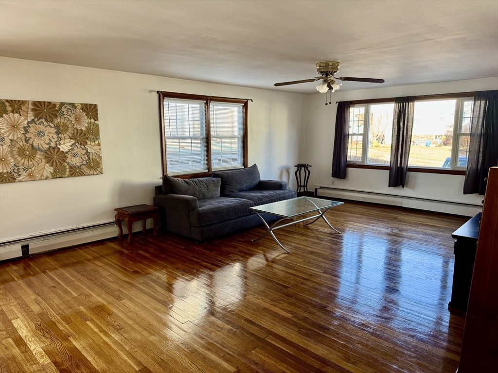 156 Nichols Avenue, Unit 1 Watertown, MA 02472 - Photo 10 of 26 a living room with furniture and wooden floor