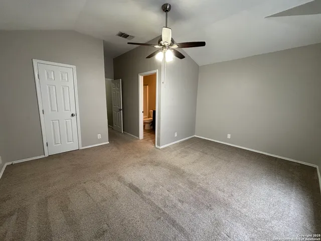 a view of a chandelier fan and a ceiling fan in a room