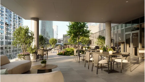 a living room with furniture and large windows